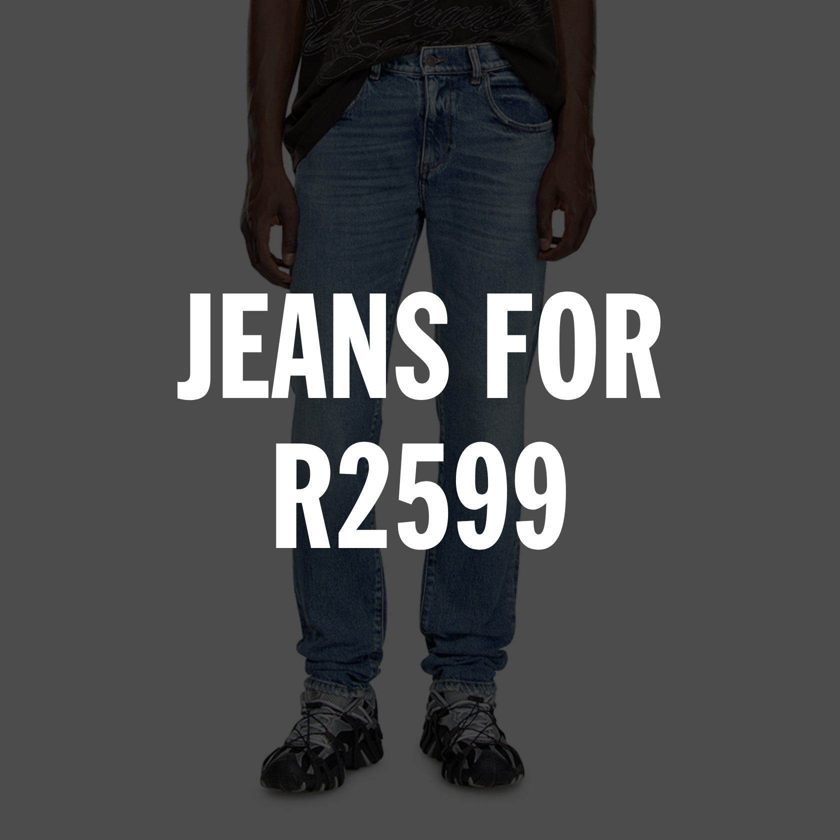 Person wearing blue denim jeans and black sneakers with text 'JEANS FOR R2599'