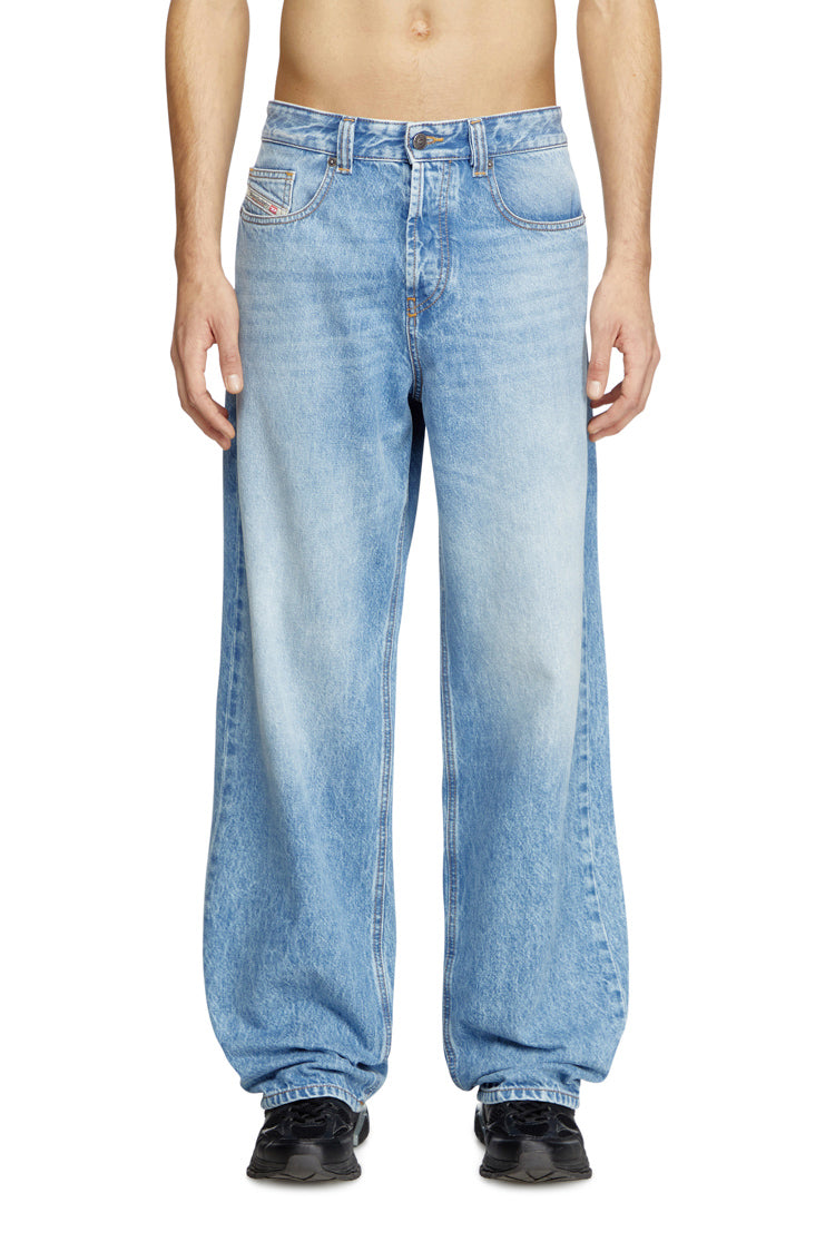 Person wearing light blue jeans on a white background