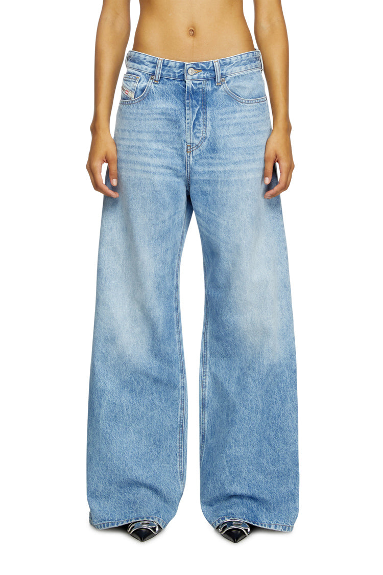 person wearing blue baggy jeans on a white background