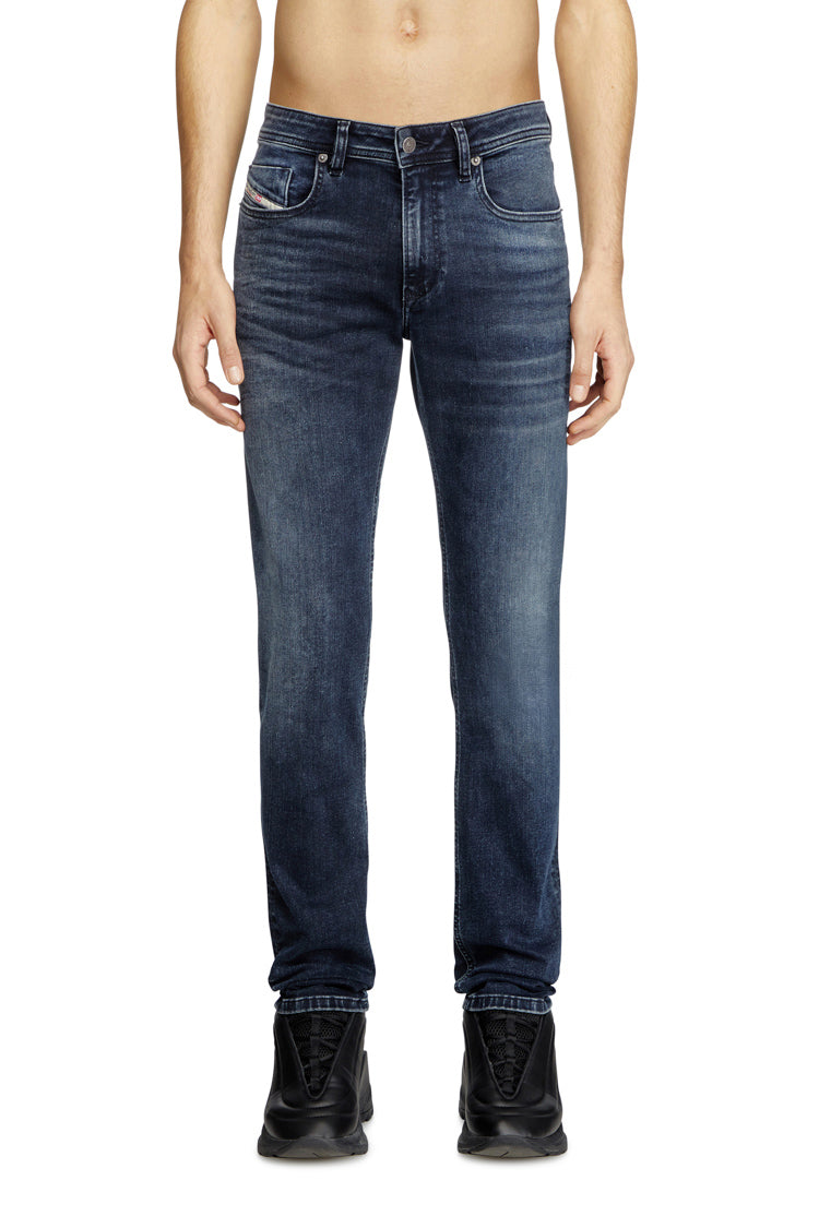 Blue jeans worn by a person on a white background