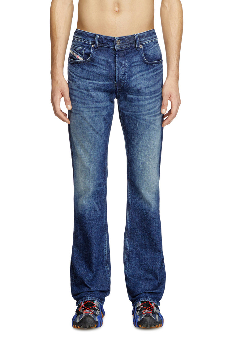 Blue jeans worn by a person on a white background